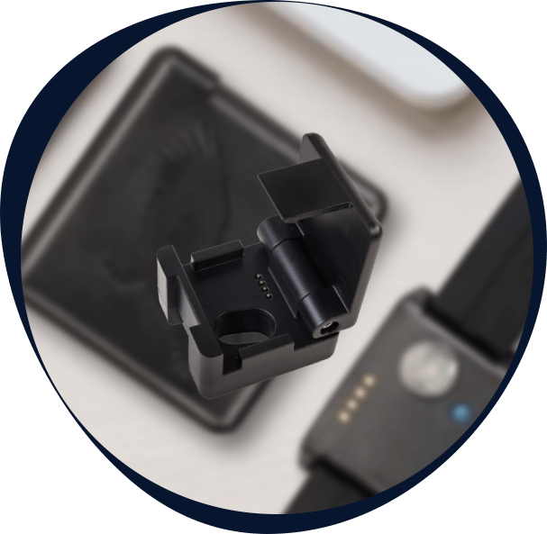 Wearable sleep monitoring device and charging dock used in decentralized sleep research protocols.