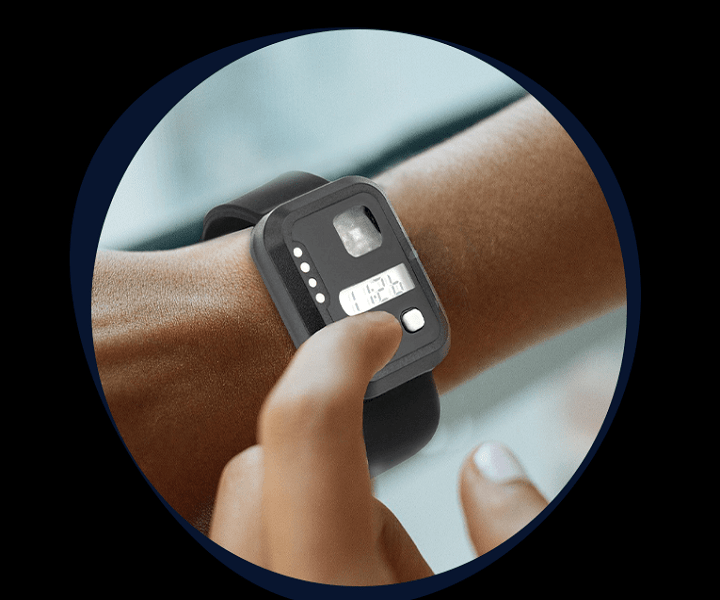 A photo showing an actigraphy device on a person’s wrist.