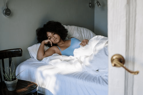 a woman trying to sleep on her bed