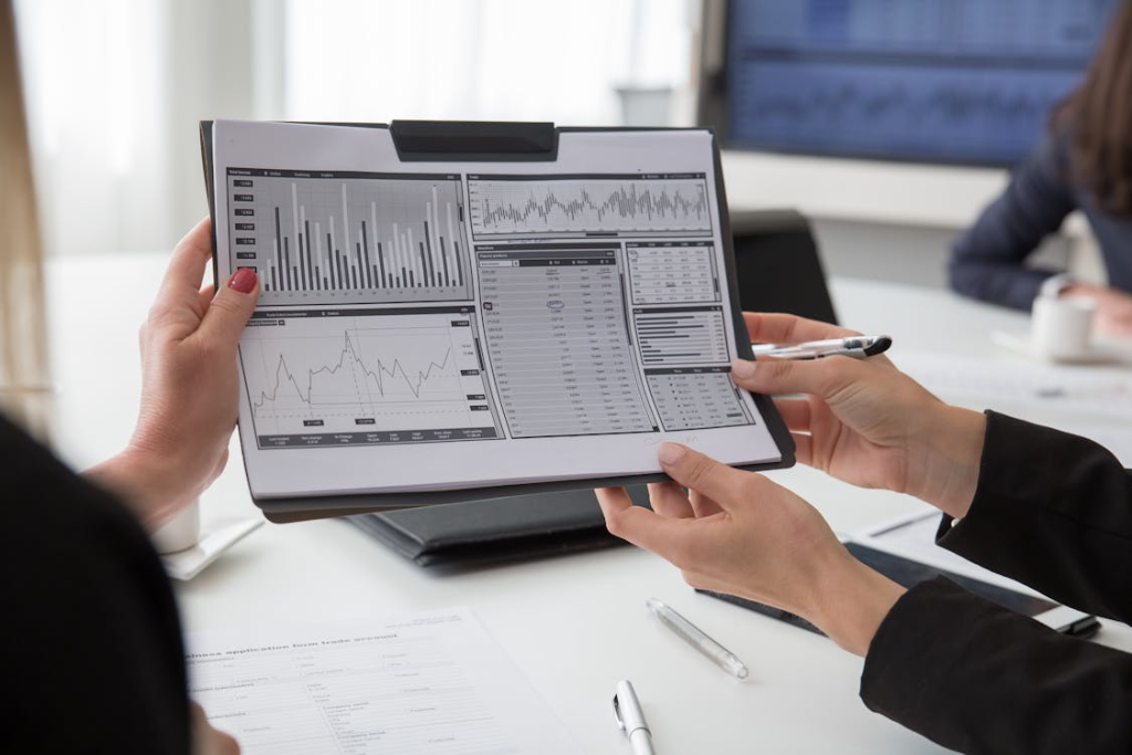 Researchers reviewing charts and performance metrics related to wearable sensor data quality and study compliance