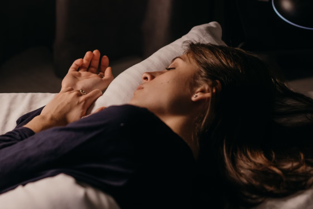 Research participant sleeping comfortably at night while contributing data to a circadian health and sleep monitoring study.