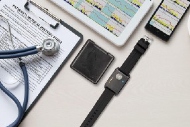 Wrist actigraphy device, stethoscope, patient medical history form, tablet, and phone displaying sleep data charts.