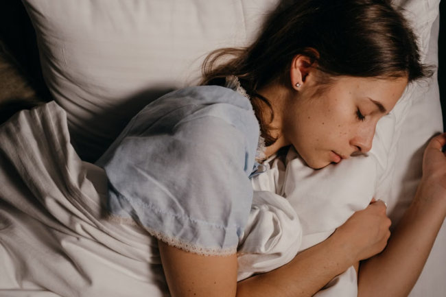 Individual sleeping peacefully in bed during a study focused on sleep behavior and circadian rhythm assessment.